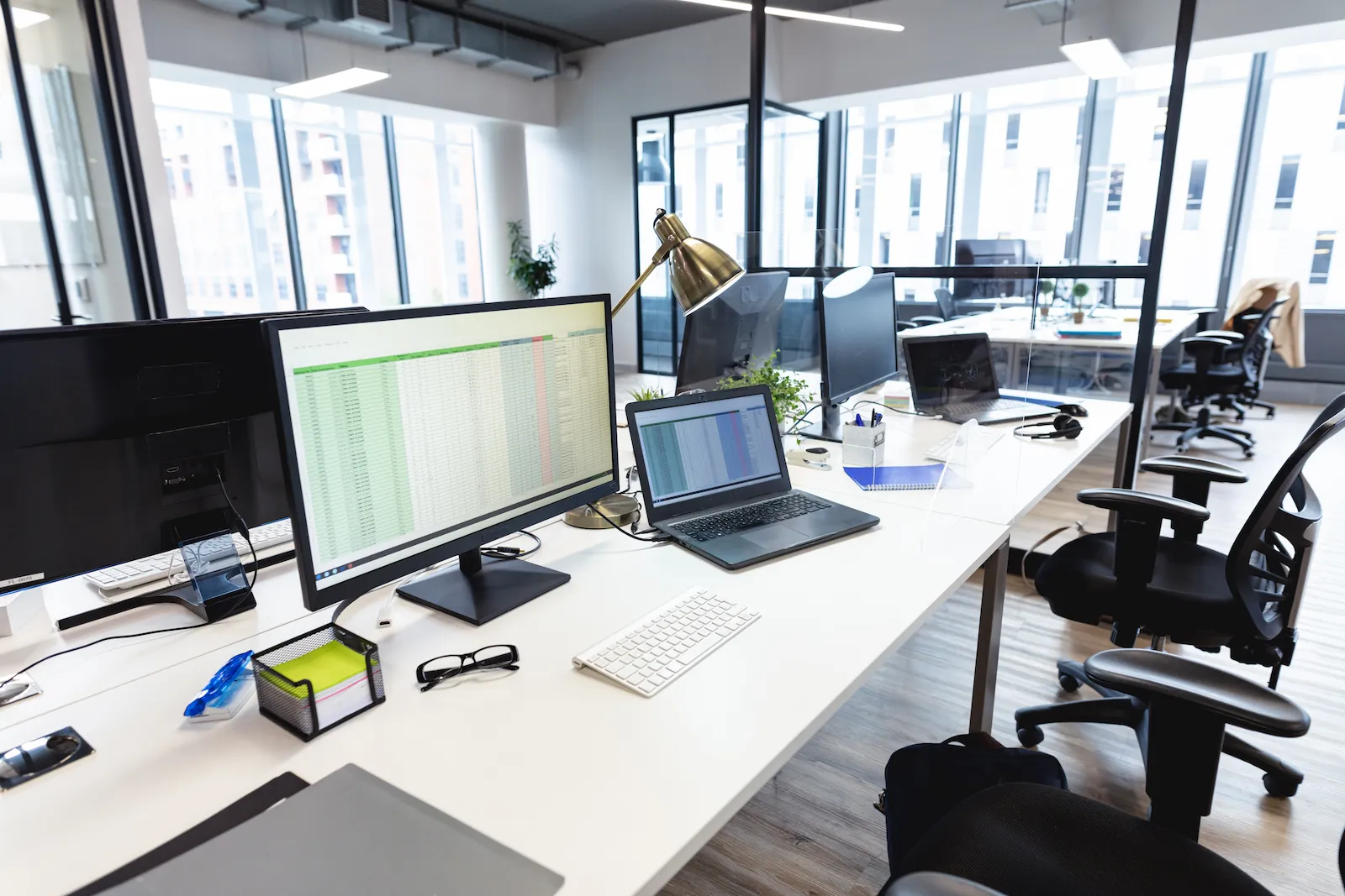 A wide view of the engineering operations centre with the team at work and a building model on the wall display