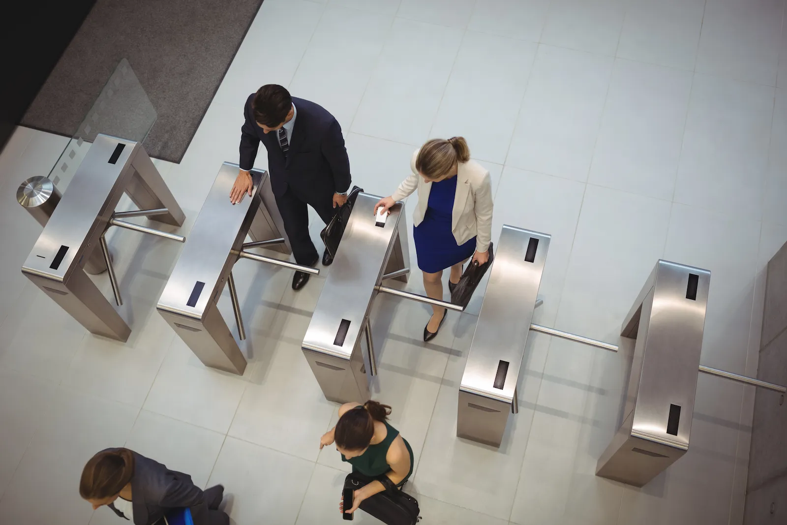 A visitor checking in at a construction site entrance on a tablet kiosk